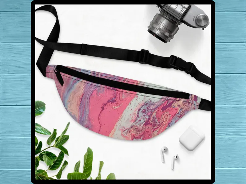 Zoomed view of the pink and purple marble print showing the artistic pattern of this pink sac banane with abstract design. Lightweight and compact, this Greek inspired bag is part of the Sea Sun Stories fanny packs range for summer style.