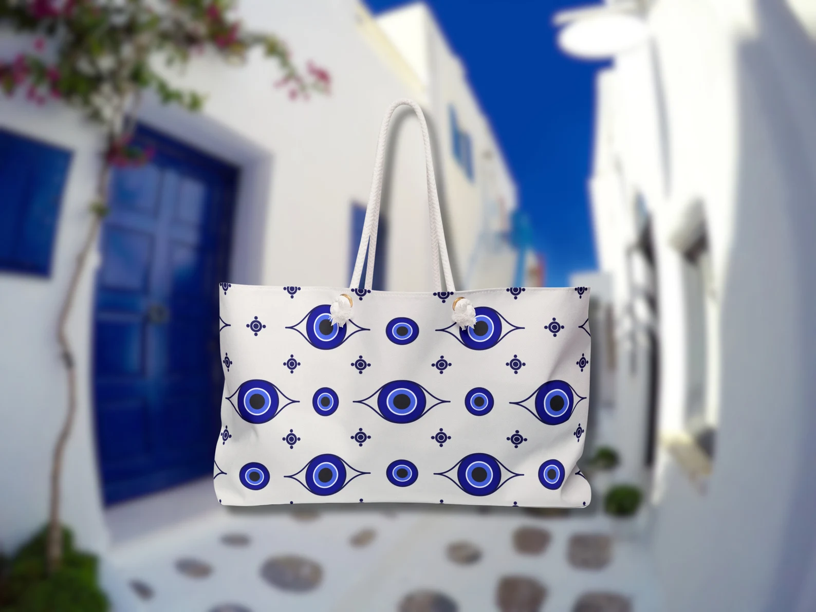 This blue and white Greek bag is captured in Mykonos island. As a Greek style bag for the beach, it holds your beach essentials with ease. Rope handles make it easy to carry while traveling to Greece. This Greek evil eye protection bag is practical and symbolic.