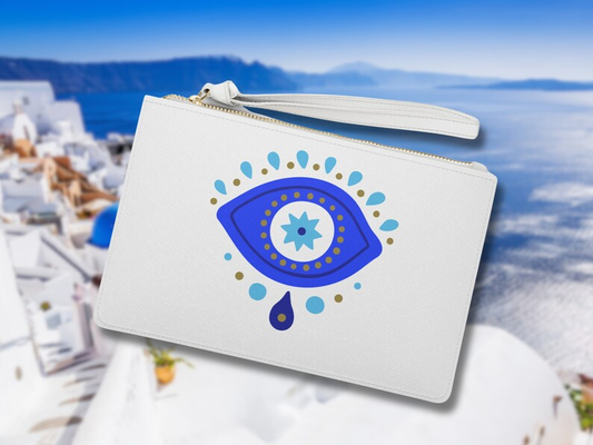 Evil Eye Clutch Bag, prominently displaying its iconic Greek evil eye bag motif. This white clutch, crafted from vegan leather bag material, boasts a sleek finish. The blue white clutch design, combined with a secure zip top clutch white, makes it a striking evil eye handbag for any occasion.