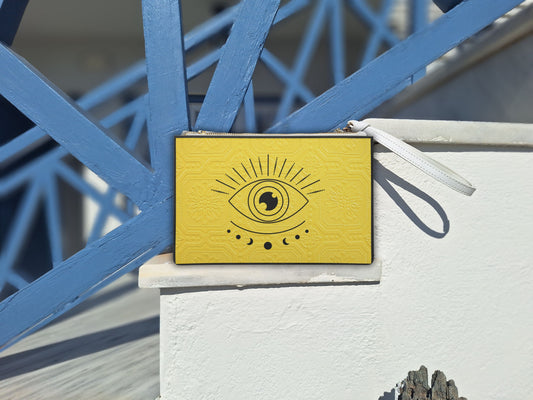 The faux leather clutch is beautifully presented by the Aegean Sea on a Greek island, highlighting its durable yet stylish design. This yellow black purse is an essential summer clutch for seaside adventures. Its compact size and vibrant color make it an ideal evening clutch for resort wear.