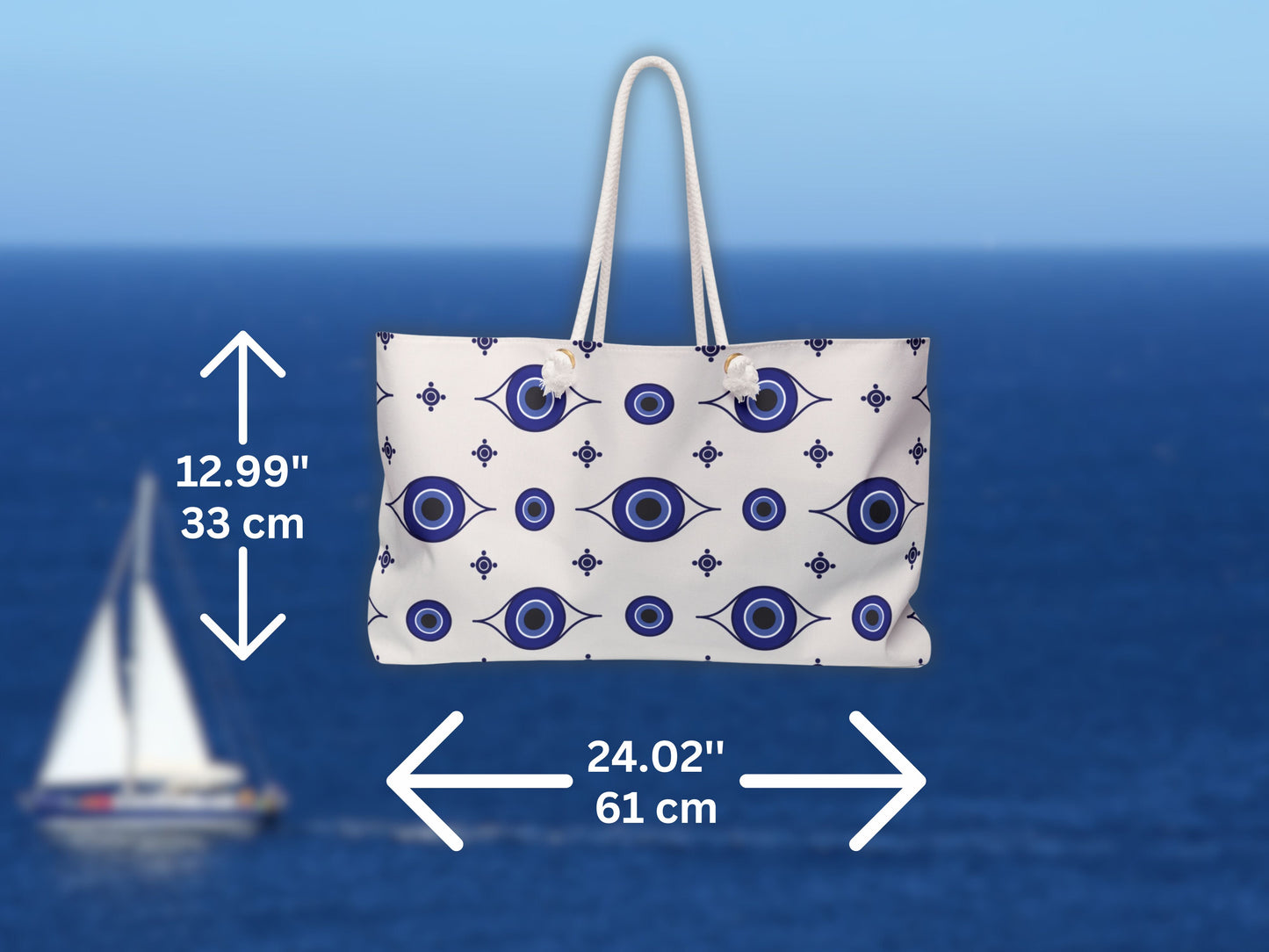 Detailed view of the Greece inspired travel bag with dimensions marked clearly. This blue and white Greek bag is perfect as a travel to Greece essential. With its roomy structure, rope handles, and evil eye design, this Greek shoulder bag fits beach towels, clothing, and sunscreen for every Santorini summer bag need.