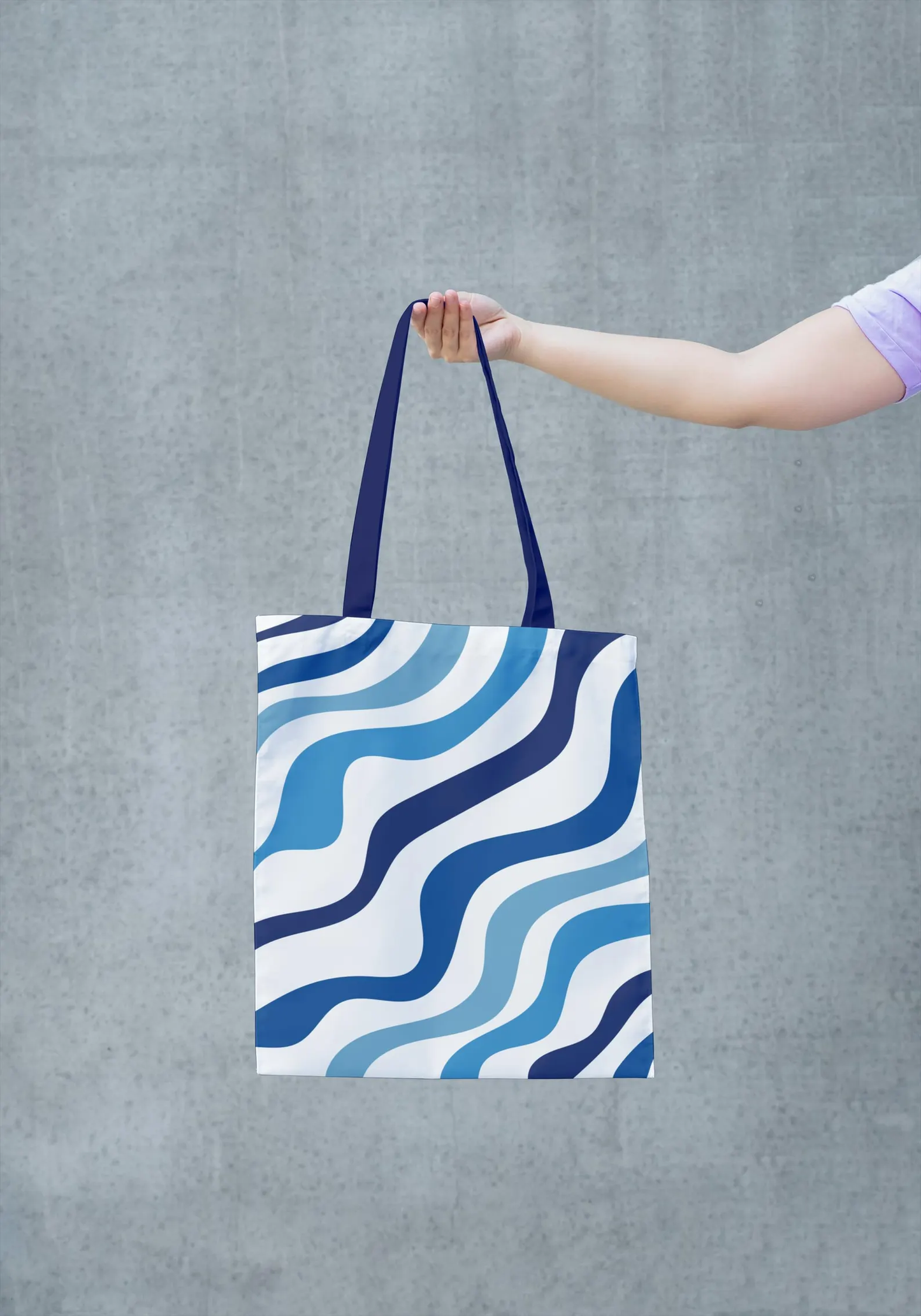 A close-up image of the Blue Tote Bag, highlighting the details of the blue and white pattern and the texture of the fabric. This image allows you to appreciate the artistry and quality of the bag's construction. The vibrant colors and intricate design make it a unique and stylish accessory. This image showcases the bag's high-quality materials and craftsmanship.