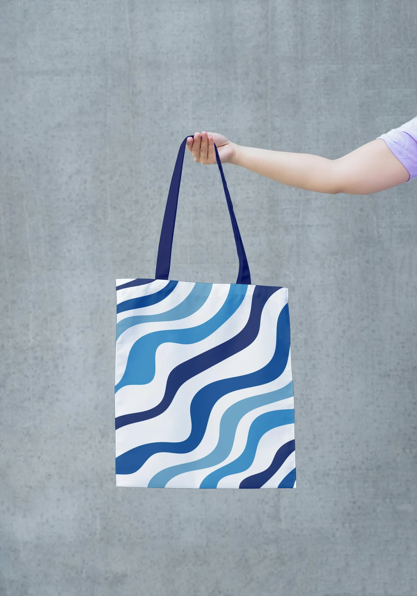 A close-up image of the Blue Tote Bag, highlighting the details of the blue and white pattern and the texture of the fabric. This image allows you to appreciate the artistry and quality of the bag's construction. The vibrant colors and intricate design make it a unique and stylish accessory. This image showcases the bag's high-quality materials and craftsmanship.