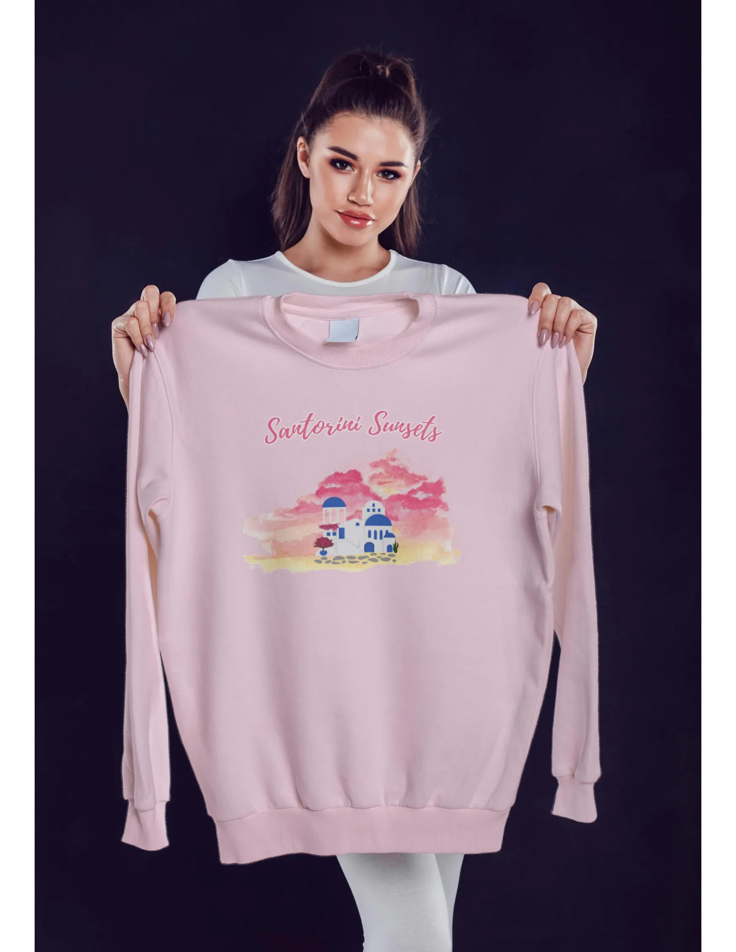 A model holding the Vacation sweater  in light pink, layered with other clothing, illustrating its adaptability for different looks.