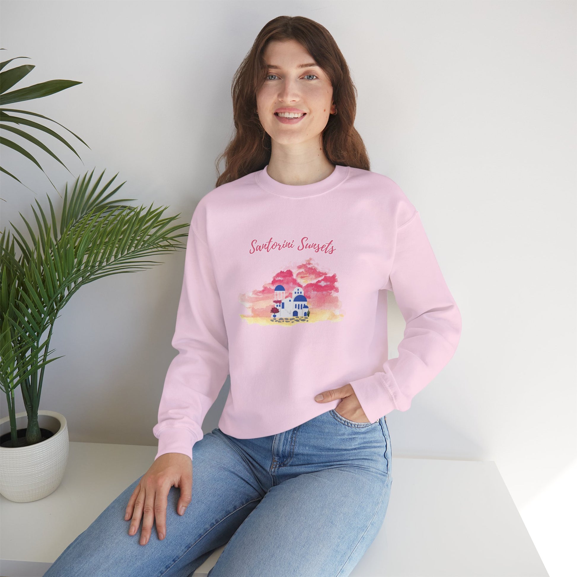 A model wearing the Greece vacation sweater, showcasing its relaxed fit and the beautiful Watercolor Graphic inspired by the Santorini sunset.