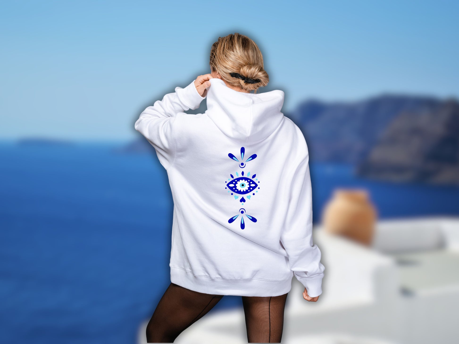 A model wearing the greek eye hoodie, emphasizing the visibility and impact of the spiritual symbol.