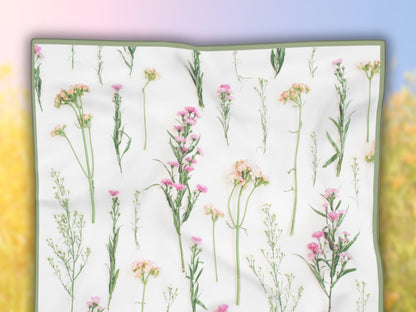 Detailed flat lay highlighting the real flowers on this white scarf floral.
